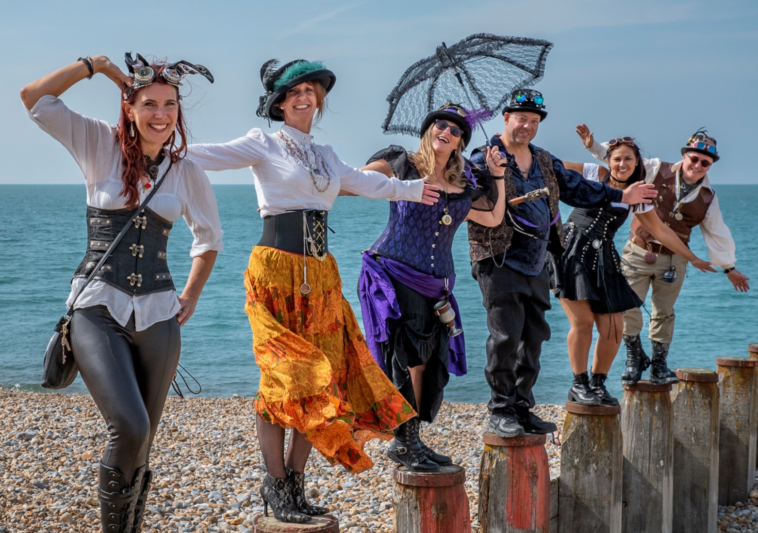 A group of Steampunk enthusiasts pose on top of groines on Eastbourne Beach